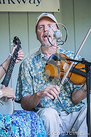 Male Singing and Playing a Violin Editorial Stock Photo